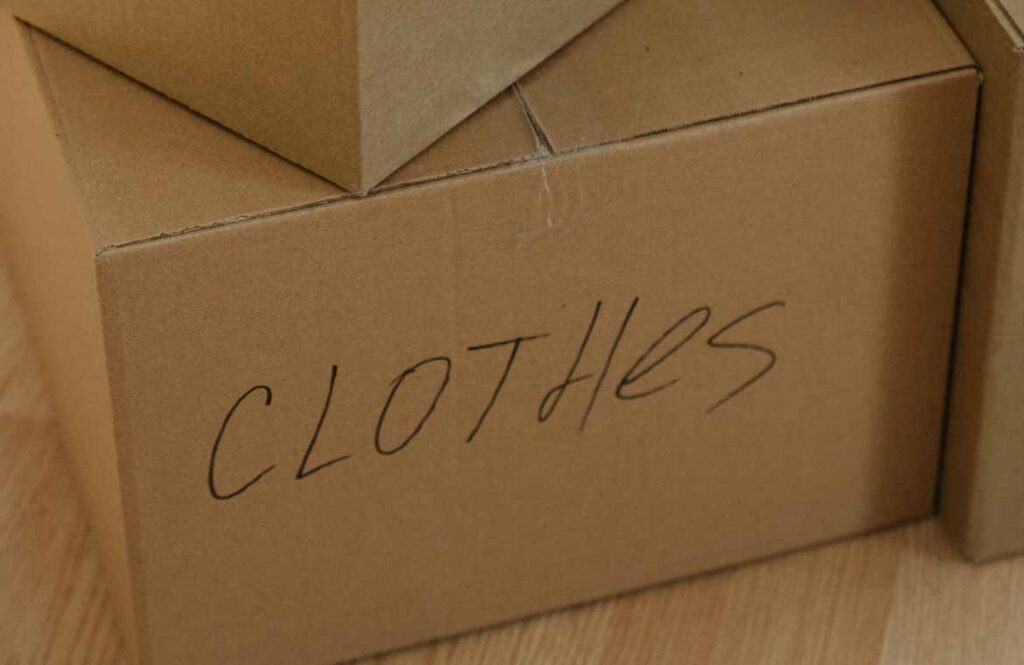 Cardboard moving box labelled by hand with the destination room and a coloured marker Cardboard moving box labelled by hand with the destination room and a coloured marker