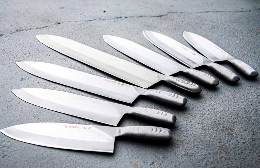 Kitchen knives wrapped in paper and secured before being packed into a moving box Kitchen knives wrapped in paper and secured before being packed into a moving box