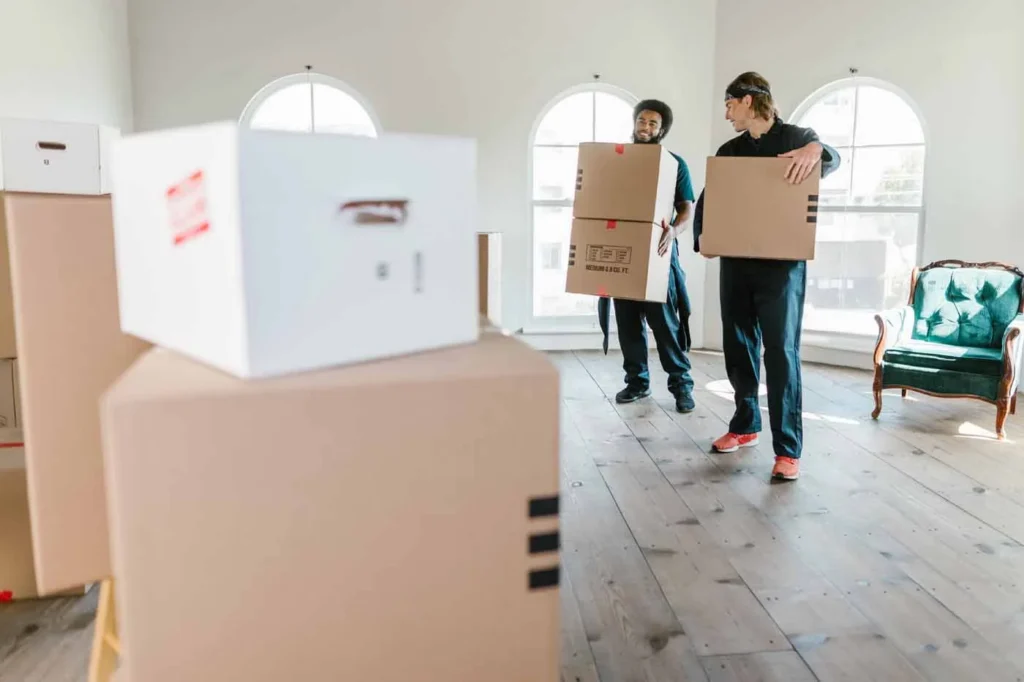 Movers carrying furniture during a house move in East Auckland